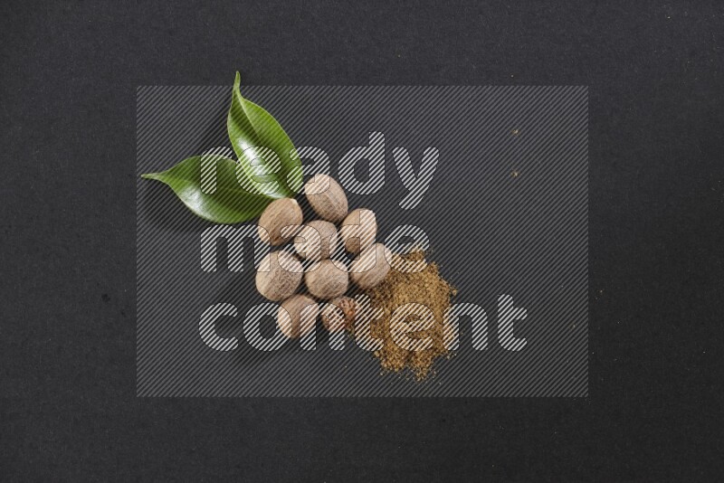Nutmeg seeds with nutmeg powder beside it on a black flooring in different angles
