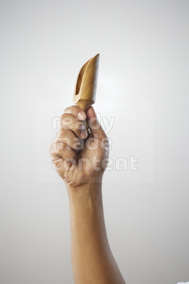 Male Hand Holding Wooden scoop