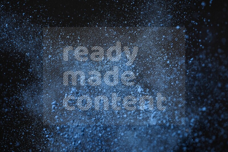 Blue powder explosion on black background