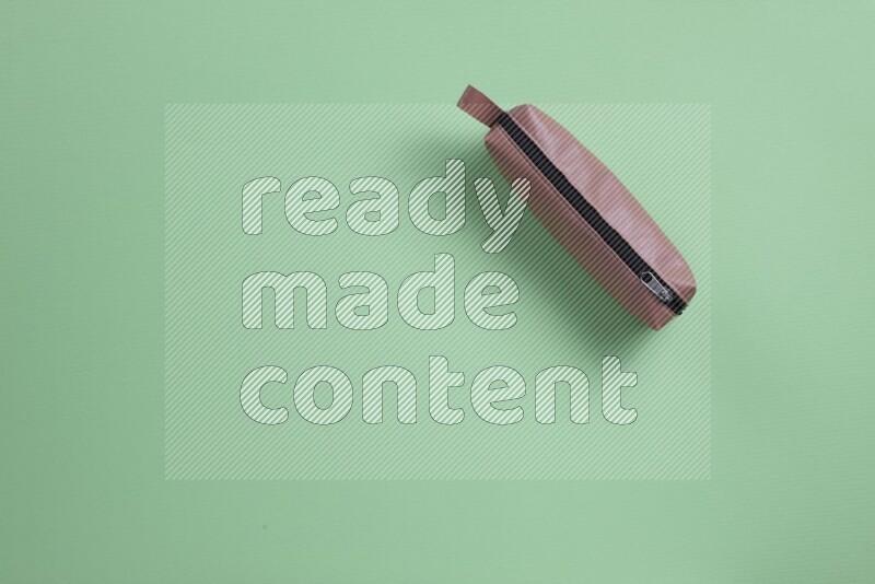 Different school supplies on green background