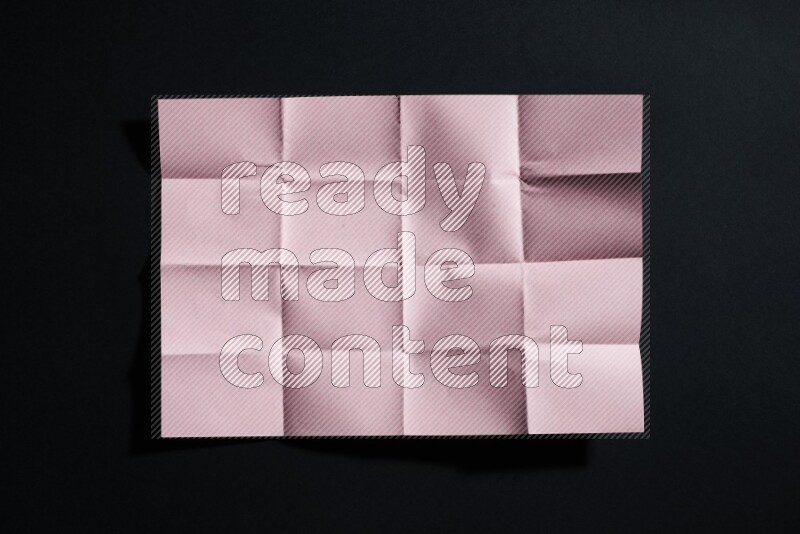 Pink paper sheet on black background