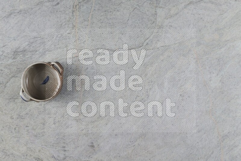 A multicolored pottery Bowl on grey marble background