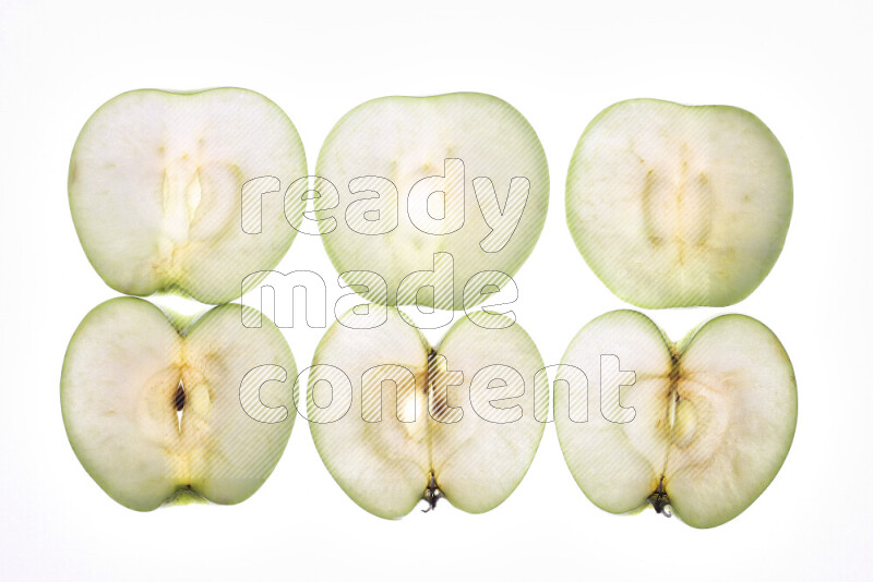 Apple slices on illuminated white background