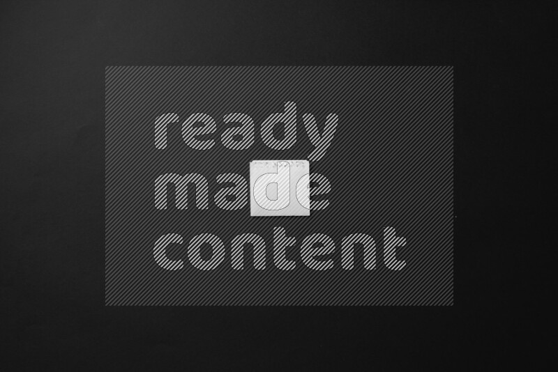 Folded notebook sheet on black background