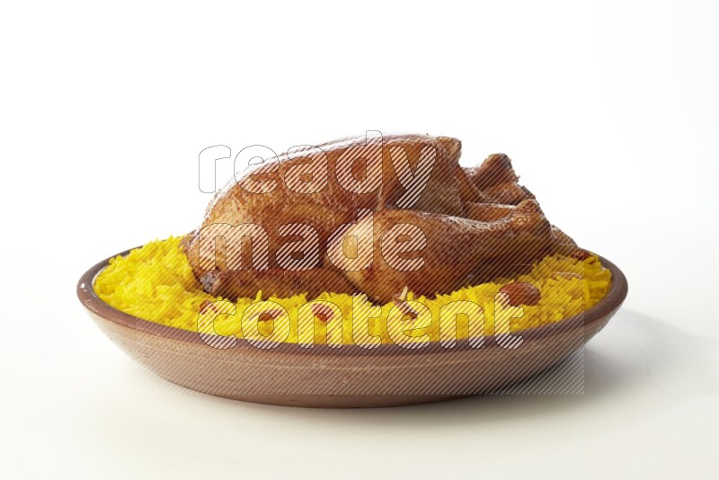 yellow basmati Rice with whole roasted chicken  on a pottery plate  direct  on white background