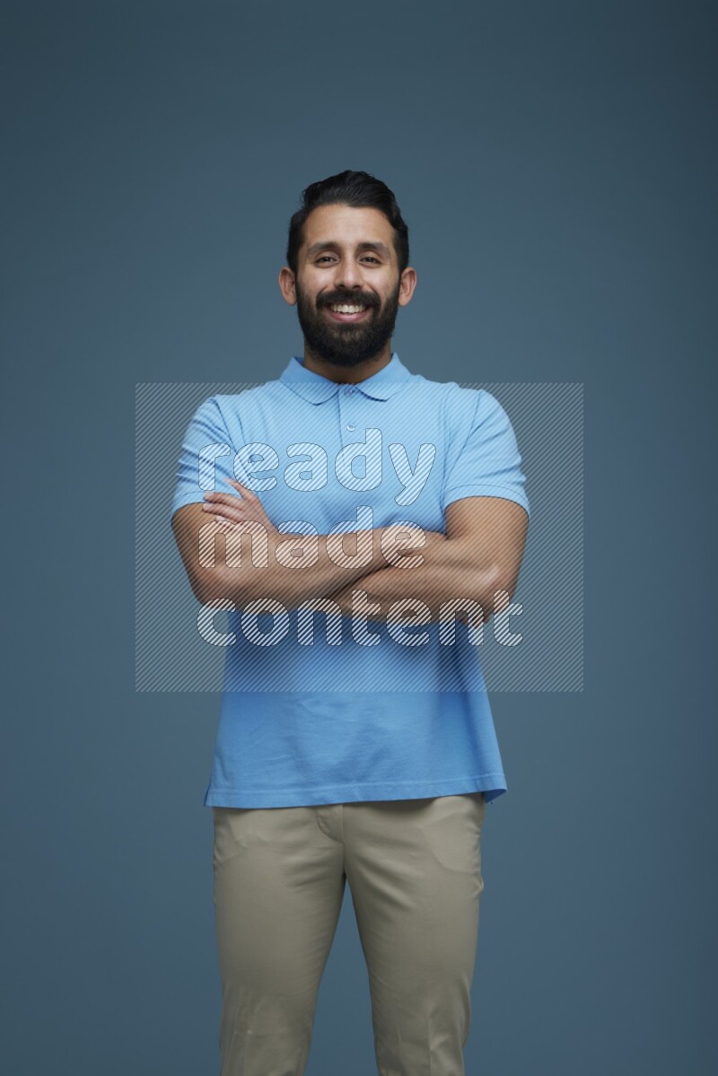 Man posing in a blue background wearing a Blue shirt