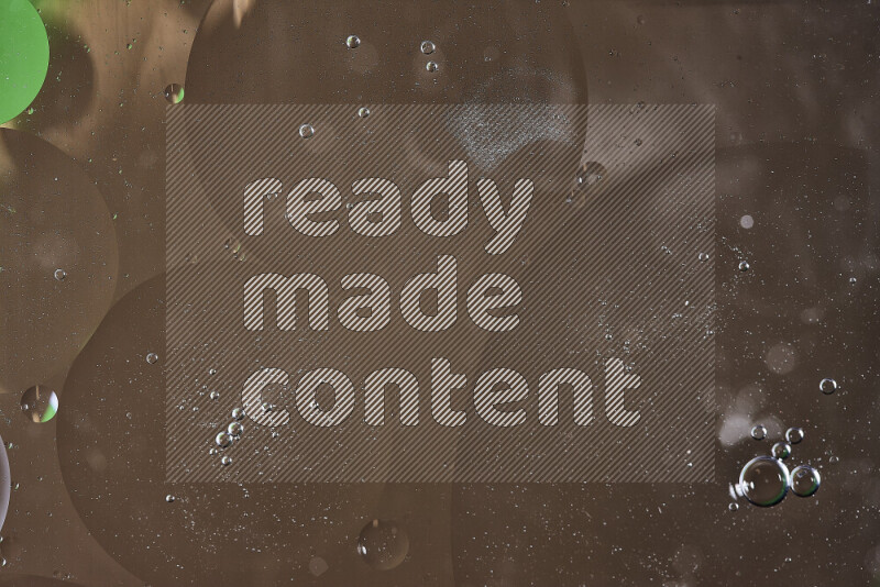 Close-ups of abstract oil bubbles on water surface in shades of green and brown