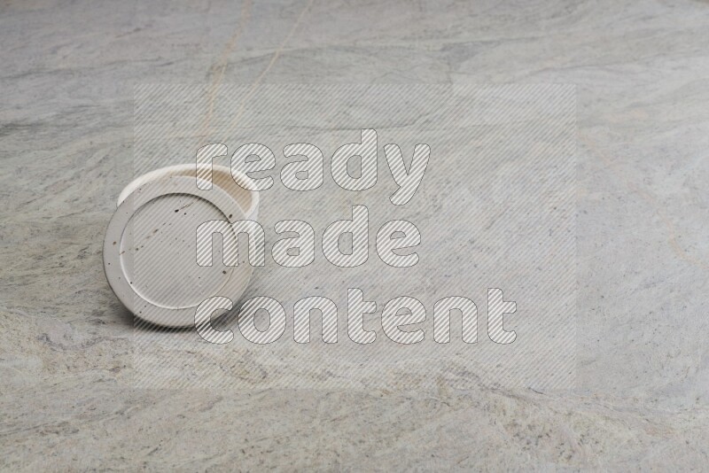 A white pottery bowl on grey marble background