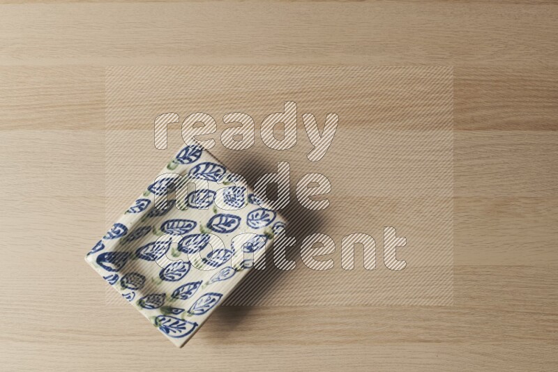 A decorative pottery plate on light wooden background