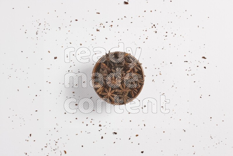 Star Anise in a wooden bowl on white flooring