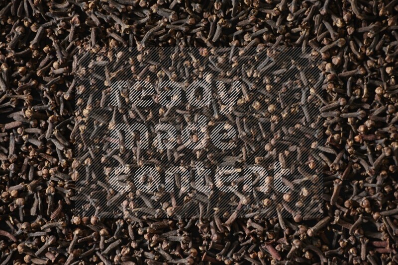 Cloves spread on black flooring