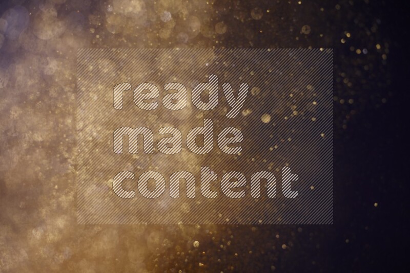 Gold glitter powder isolated on black background