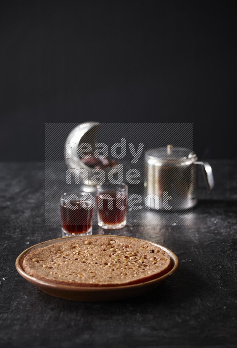 Basbousa with tea in a dark setup