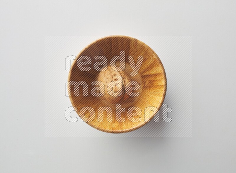 Top-view shot of walnut in a container on white background