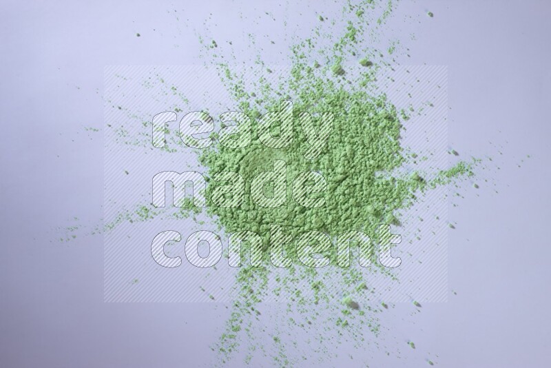 Green powder on white background