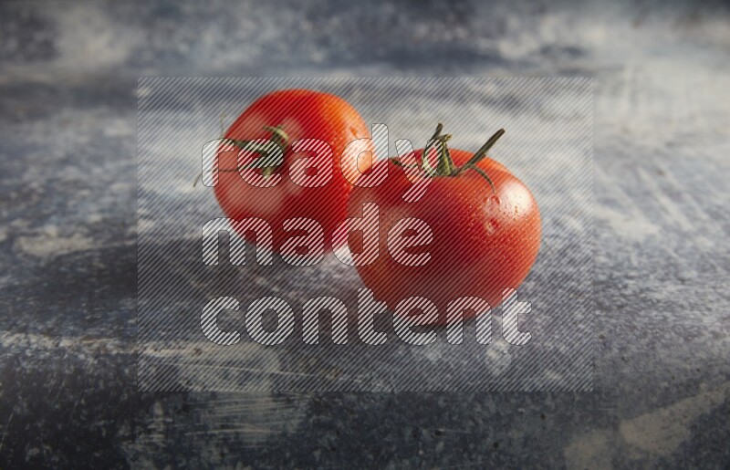 45 degree roma tomato on a textured rustic blue background