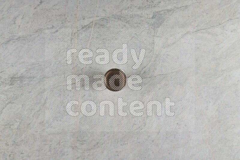 A multicolored pottery Cup on grey marble background