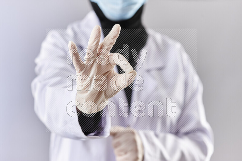 طبيبة ترتدي عباءة وملابس طبية في أوضاع متعددة