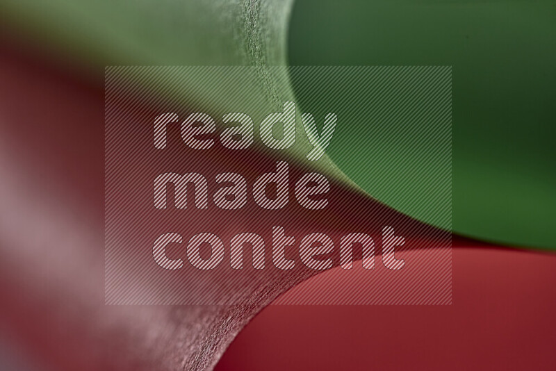An abstract art showing red and green paper sheets arranged in an overlapping curves