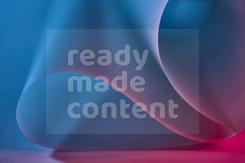 An abstract art piece displaying smooth curves in blue and pink gradients created by colored light