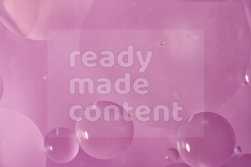 لقطات مقربة لفقاعات من الزيت على سطح الماء باللون الوردي