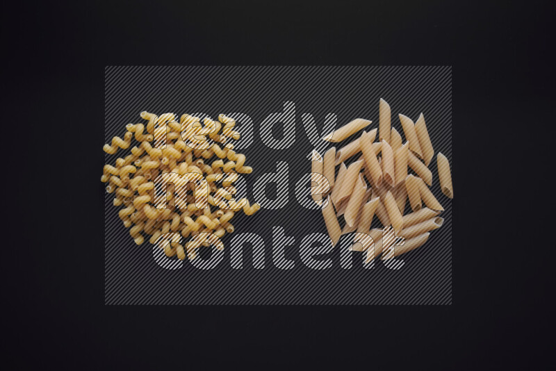 Different pasta types in bunches on black background
