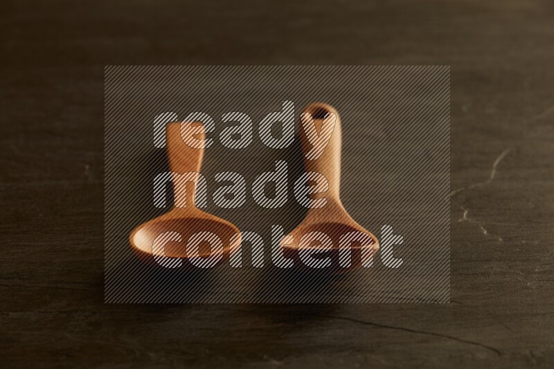 wooden spoon on black slate background