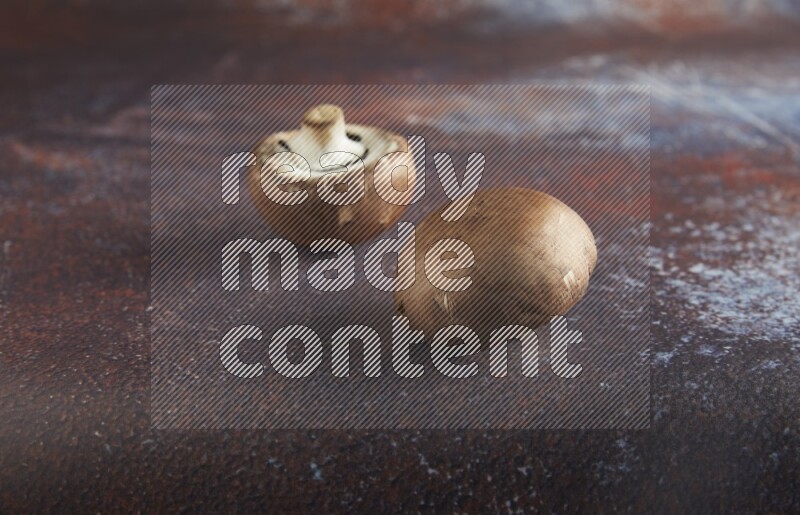 45 degre cremini  mushrooms on a textured reddish rustic metal background
