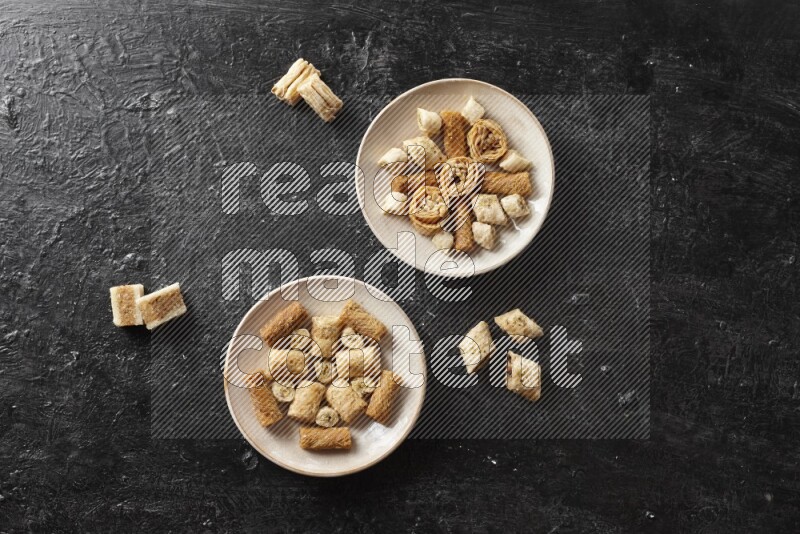 Oriental sweets in pottery plates in a dark setup