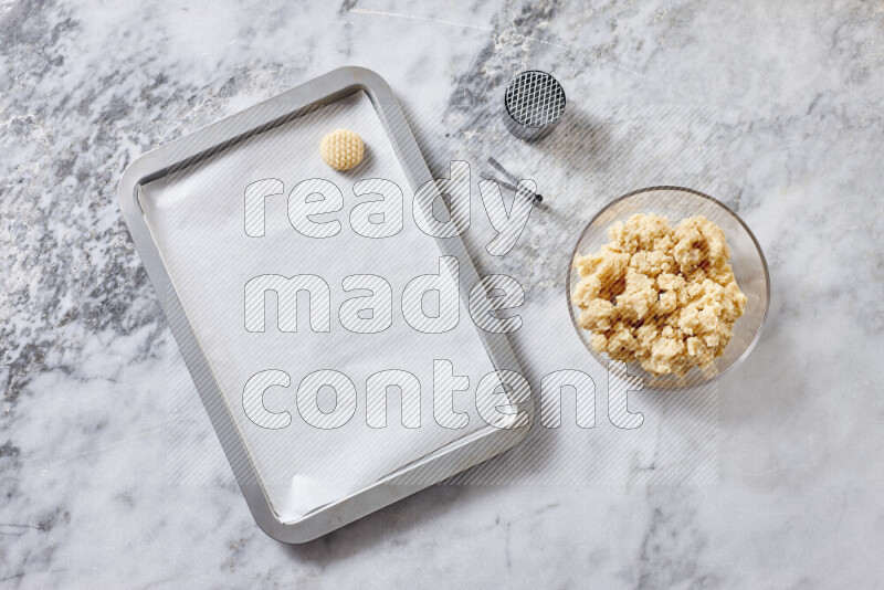 Kahk step by step with its ingredients ghee, sugar, flour, sesame, yeast, water and kahk flavor on grey marble background