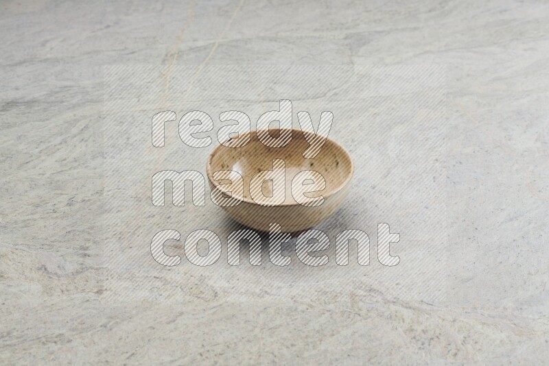A multicolored pottery bowl on grey marble background
