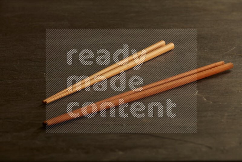 wooden chopsticks on black slate background