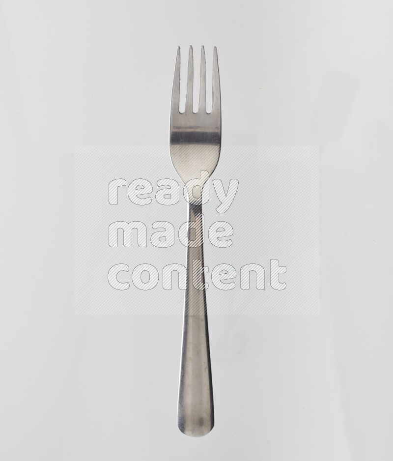 Silver stainless steel fork on white background