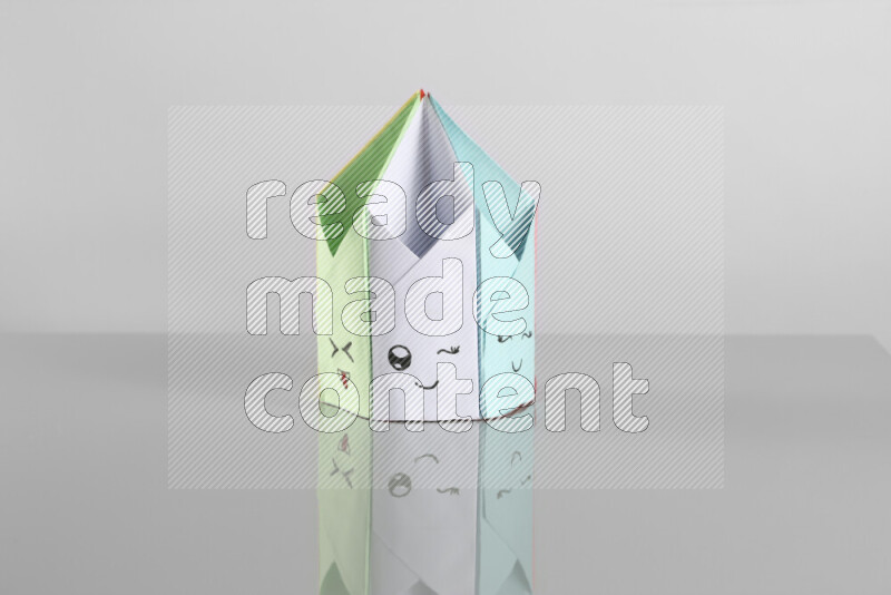 Origami pen holder on grey background