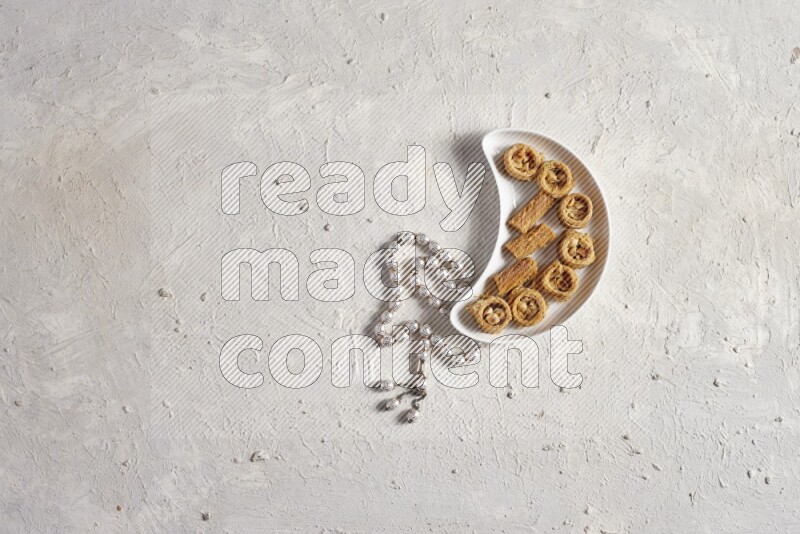 konafa in a pottery plate with sebha in a light setup
