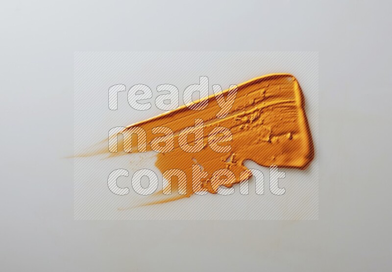 An orange straight painting knife stroke on white background