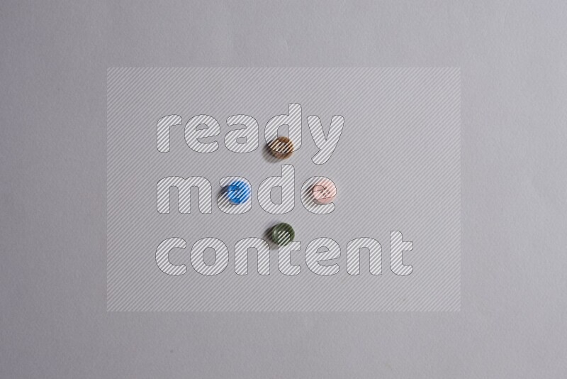 Multicolored buttons placed on grey background