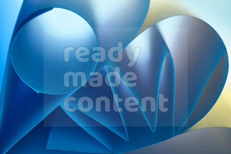 An artistic display of paper folds creating a harmonious blend of geometric shapes, highlighted by soft lighting in blue and warm tones