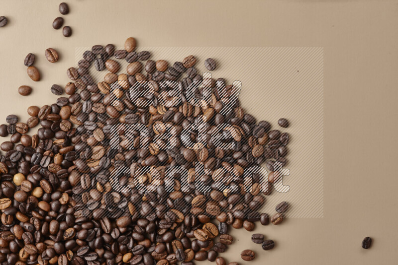 Roasted coffee beans on beige background