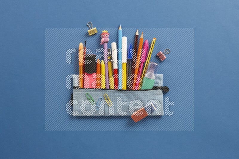 Different school supplies on blue background