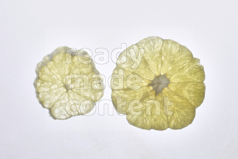 Orange slices on illuminated white background