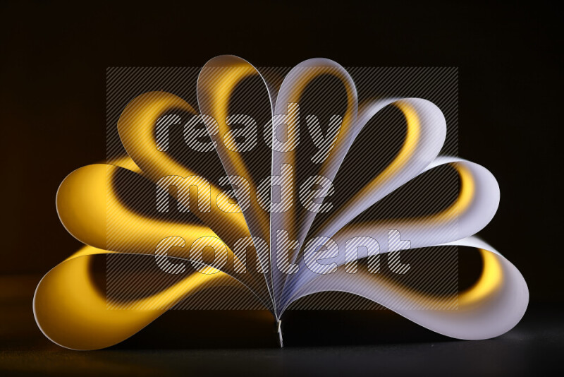 An abstract art piece displaying smooth curves in yellow and white gradients created by colored light