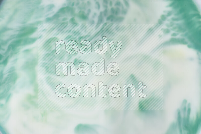 A close-up of abstract swirling patterns in green gradients