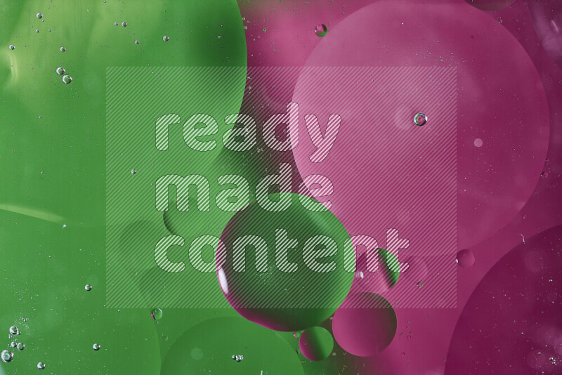 Close-ups of abstract oil bubbles on water surface in shades of green and pink