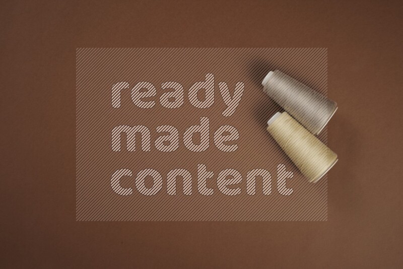 A brown collection of sewing and tailoring tools arranged on a brown background