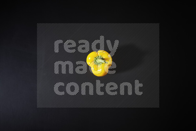Yellow bell pepper on black background