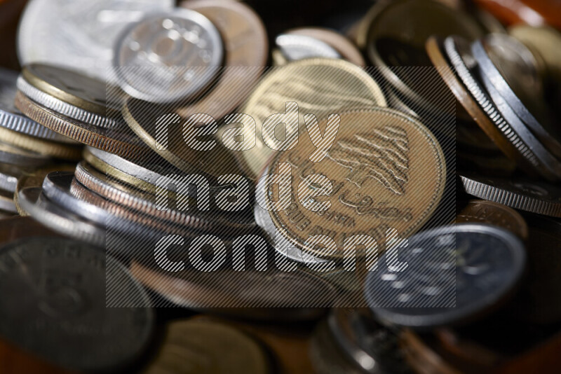 A close-ups of random old coins on black background