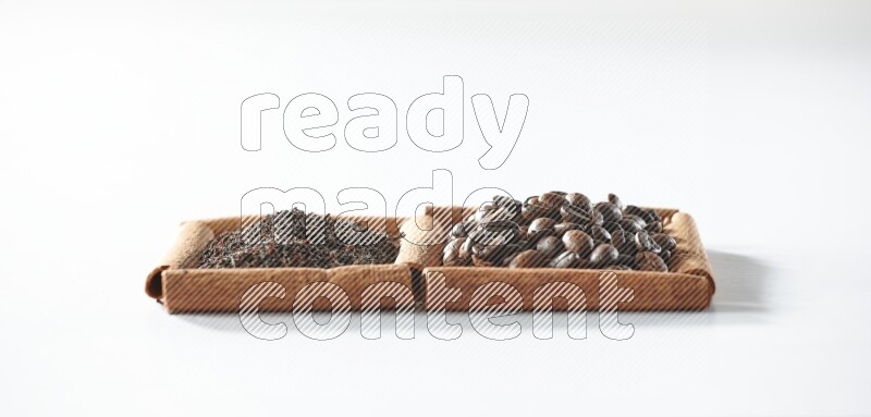 2 squares of cinnamon sticks full of coffee beans and black tea on white flooring