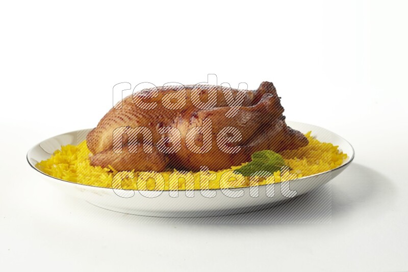 yellow  basmati Rice with kabsa chicken pieces on a white plate with a silver rim direct on white background