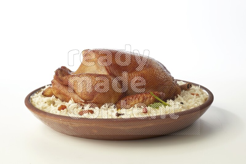 white  basmati Rice with  whole roasted chicken    on a pottery plate  direct  on white background